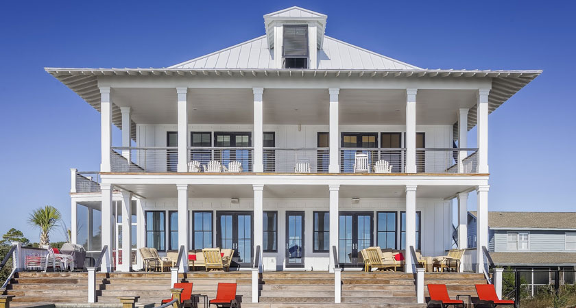 A large white house with lots of furniture.