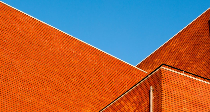 A red brick building with a blue sky in the background.