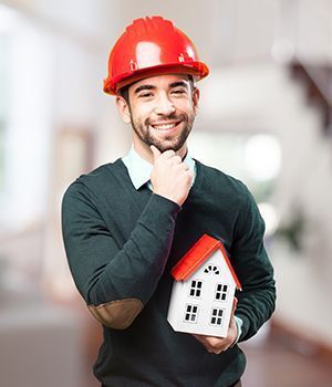 A man holding a house in his hand