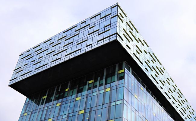 A building with many windows and glass on the top