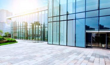 A building with glass windows and a brick floor.