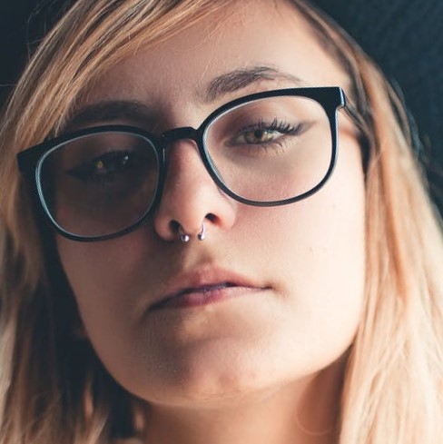 A woman with glasses and a hat on