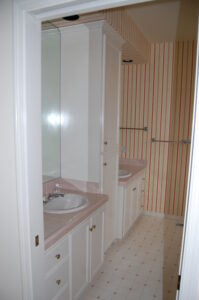 A bathroom with two sinks and a mirror.