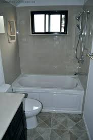 A bathroom with a tub, toilet and sink.