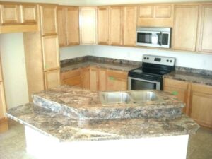 A kitchen with wooden cabinets and granite counter tops.