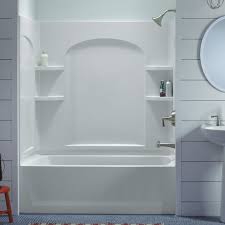 A white bath tub sitting next to a sink.